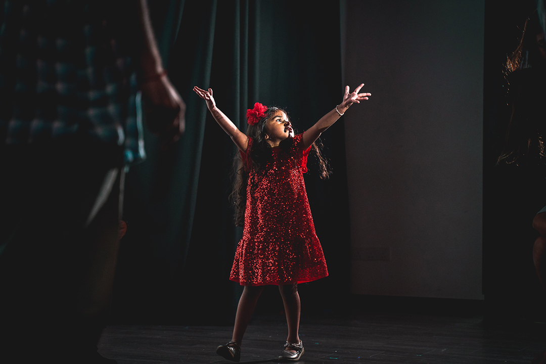 Little girl in red dress dancing
